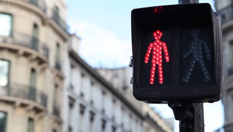 traffic light for pedestrians changing from red to green on the street