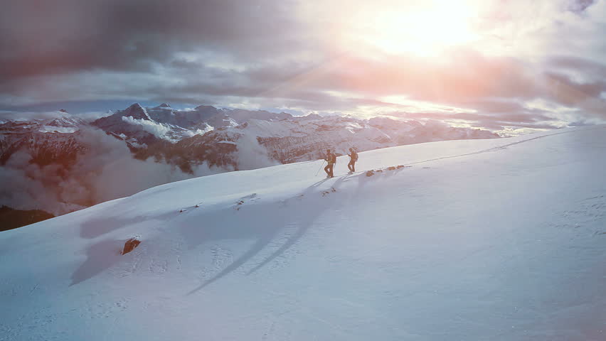 aerial view of two male hikers walking in untouched snow mountain landscape. aventures journey trip scenery of people climbing together on extreme winter expedition tour  Royalty-Free Stock Footage #26843110