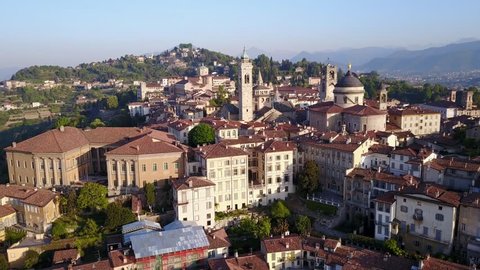 Drone aerial view of Bergamo - Old city (Città Alta). One of the beautiful city in Italy. Landscape on the city center and its historical buildings during a wonderful blu day