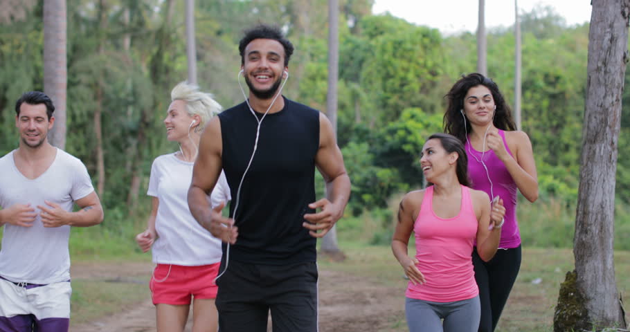 Running People Runners Man And Woman Group Talking While Training Outdoors Exercising On Forest Road, Young Smiling Friends Jogging Together In Park Slow Motion 60