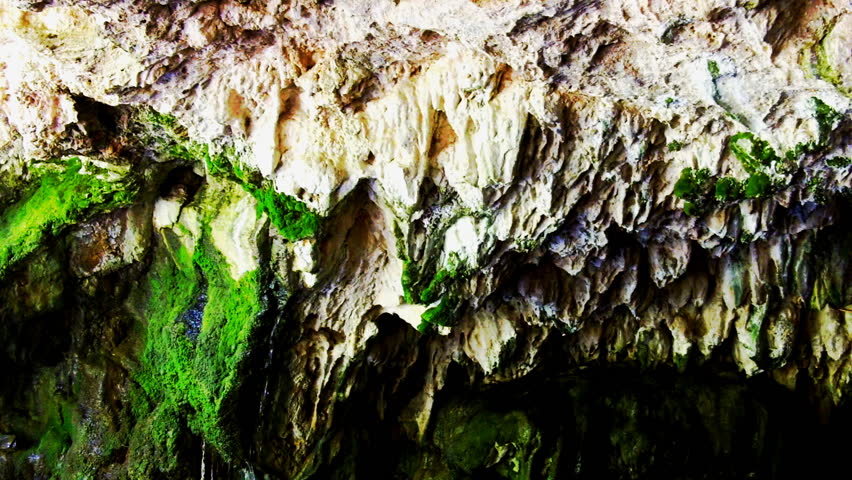 Spring water drips from the roof of a limestone underground river cave at