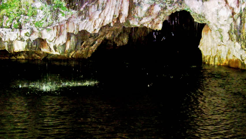 Spring water drips from the roof of a limestone underground river cave at
