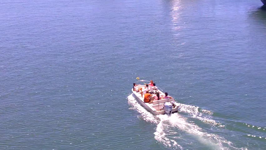 A family in a small boat heads out for a day of recreational boating fun.