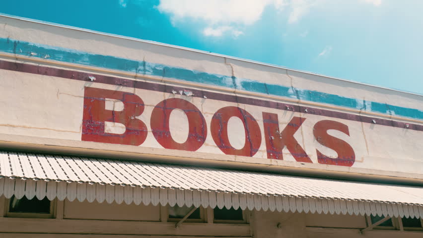 BOOKS sign at old bookstore with time-lapse sky and clouds 