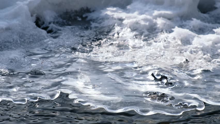 Video of closeup mooving along tracery edge of an ice floe on Altai creek in Spring season.  Siberia, Russia
