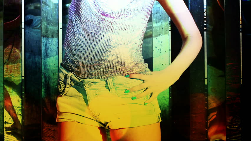 a sexy gogo dancer shot against a unique coloured chrome metal background