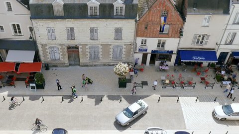 AMBOISE, FRANCE - CIRCA 2017: Aerial view of Place Michel Debre in central Amboise with restaurants cafe and bars full with people tourist travelers and majestic Amboise Chateau Castle