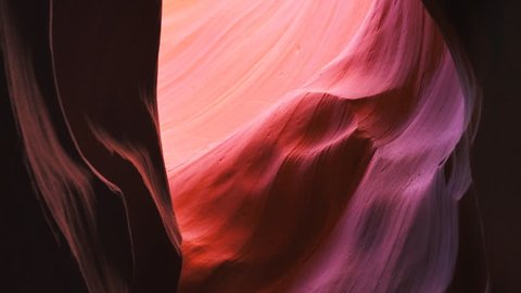 tilt down shot of a beautifully colored sandstone wall in upper antelope canyon at page, arizona