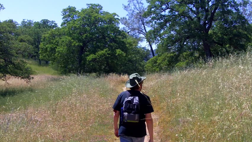 A man hikes a trail at New Melones Lake Reservoir. in Calaveras County near