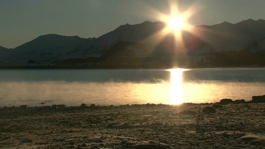 Lake Tekapo, New Zealand. Circa July 2011. Sunrise with shimmering reflections