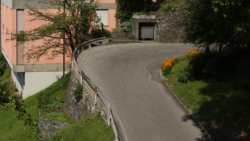 A bicycle is driving along a mountain road. Sunny day.