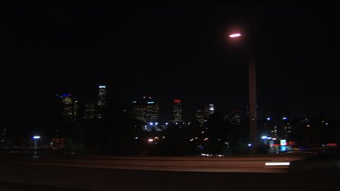 Downtown Los Angeles at night, seen from freeway; passenger POV