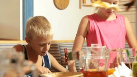 Children eating pizza in restaurant, closeup