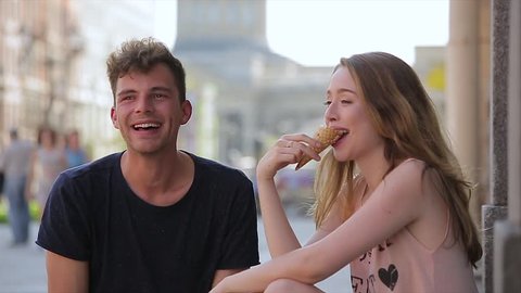 Couple eating ice cream together. Date in the city.