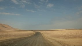 video footage of a onboard-camera in a car driving through the desert of the Paracas National Parc in Peru, south america