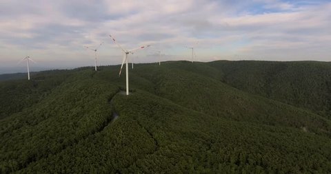 Aerial footage, wind turbines in the green forest, 4k