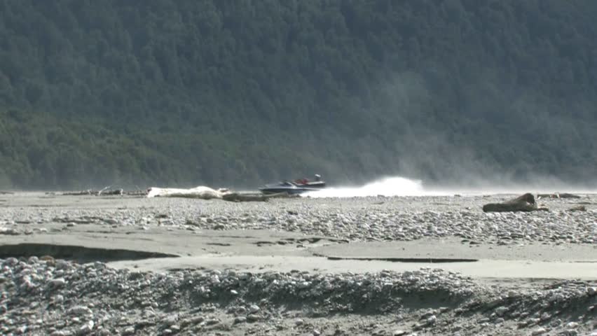 QUEENSTOWN, NEW ZEALAND - CIRCA JULY 2011: Jet boat with tourists travelling at