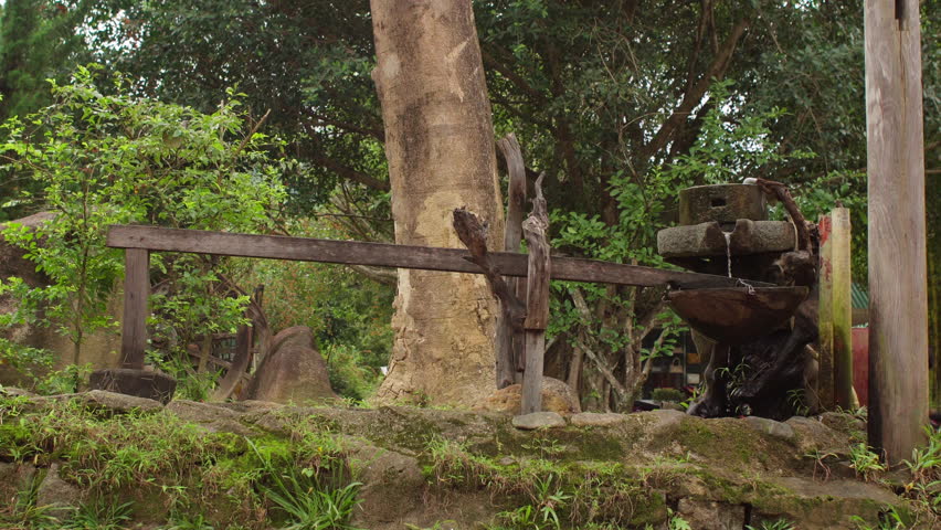 Old mechanical pounder driven by water. Ancient mechanics concept.