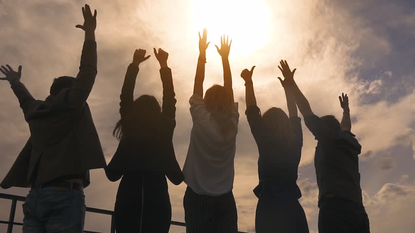 Silhouette of people rejoicing and lifting up his hands. a group of successful businessmen happy and celebrate the victory on the roof of the business center. slow motion | Shutterstock HD Video #26912788