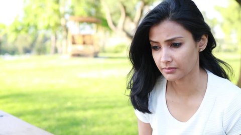 Closeup portrait, sad young woman in white shirt, hands on head, really depressed, down about something, isolated outdoors outside  background. Negative emotion facial expression feeling body language