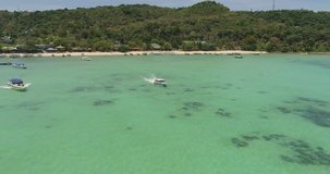 Drone flying around the boat and clear water at Phi-Phi island. Aerial video of speed boat in shallow bay. Thailand, phi phi islands, 2017.