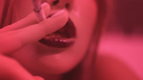 Cigarette in sexy woman lips. Sexy woman smoking cigarette. Woman smoke cigarette and blow smoke. Close up of girl smoking cigarette. Woman smoker
