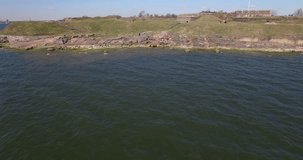 Aerial view drone footage of Suomenlinna Sveaborg fortress and lagoon on Baltic Sea with cannons, submarine and boats in bright spring day near Helsinki the capital of Finland Suomi, northern Europe