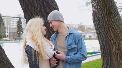 A beautiful blonde and her boyfriend are talking on a date.
