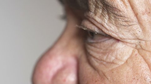 Close up on wrinkled eyes of elderly woman, profile