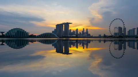 Beautiful Time lapse of Day to Night of Singapore skyline with reflection. 4K UHD. Zoom Out Camera Motion.