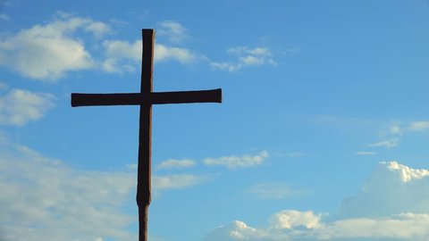 timelapse of iron Catholic Cross isolated on background of moving clouds