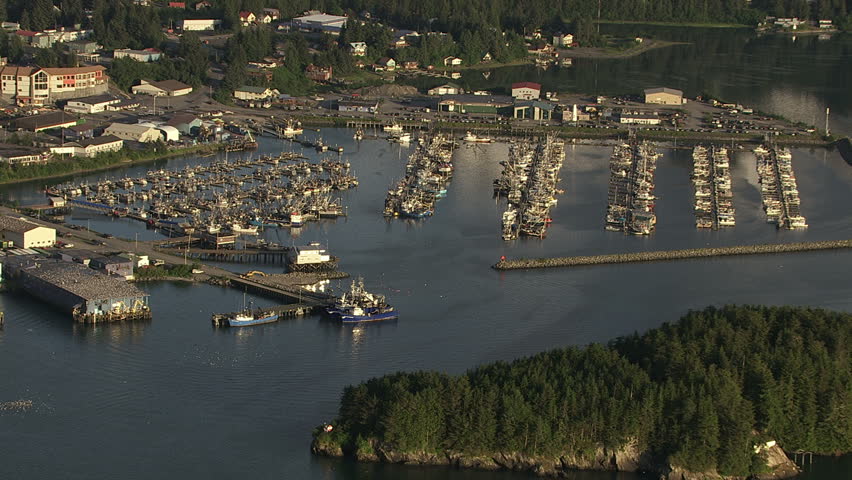 Approaching and rotating over fishing boats in harbor at Cordova, Alaska. Shot in July 2012.