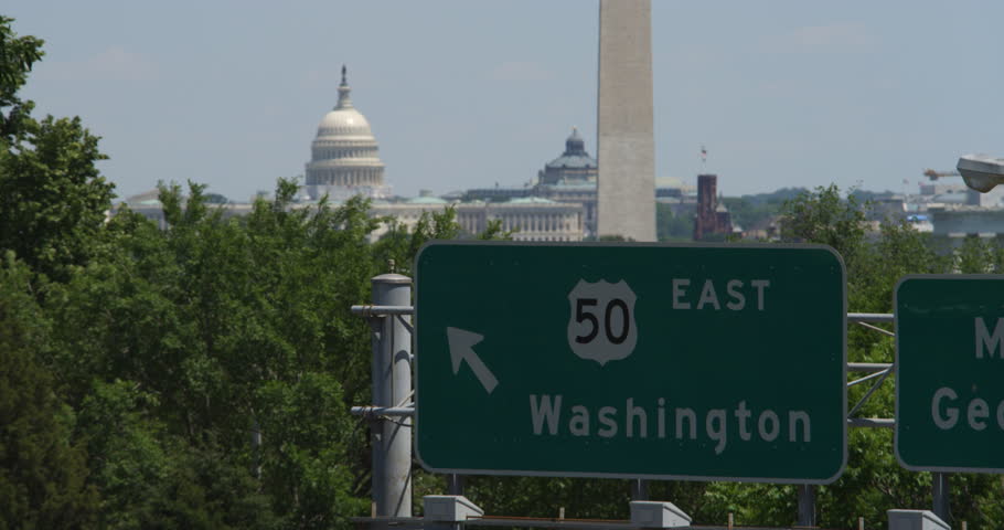 Highway 50 East sign on Memorial Bridge of George Washington Parkway with Washington DC landmarks in background. Shot in 2012.