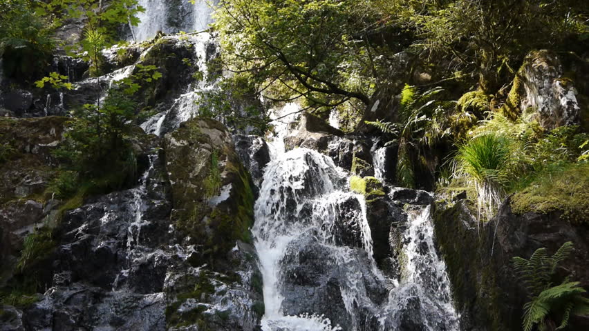 Cascade or waterfall with green rocks