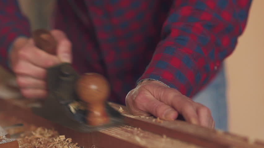 A man sawing wood Board with hand saw. Closeup. Slow motion | Shutterstock HD Video #26932297