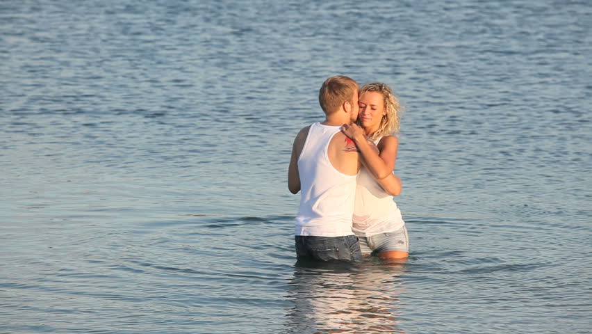 Loving couple doing sensual dance in the lake