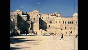 Panorama of the Western Wall Plaza in old city of Jerusalem with people. Historic restored footage on 1980s in Israel.