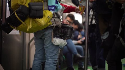 Taipei, Taiwan-12 February, 2017: 4K Profesional man photographer traveling in the subway with the camera and lens-Dan