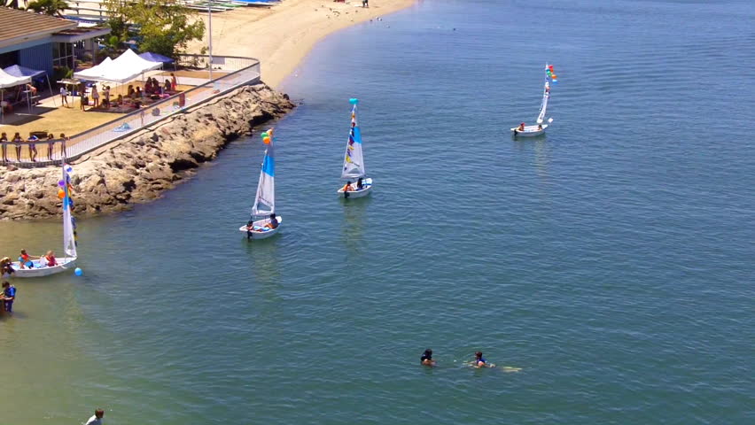 Children learn to sail small sailboats on Alamitos Bay in Long Beach, CA on a