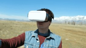 Man in 360Vr Helmet at the Lake Bank Walks Away. Young Man in Park at the Autumn Landscape Watching Video 360 Degrees in Virtual Reality Headset, Playing Virtual 360 vr Games in vr Glasses 20s 4k
