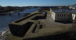 Aerial view drone footage of old Swedish and Russian bastion fortress, lagoon on Baltic Sea with cannons, submarine, boats in bright spring day near Helsinki the capital of Finland, northern Europe