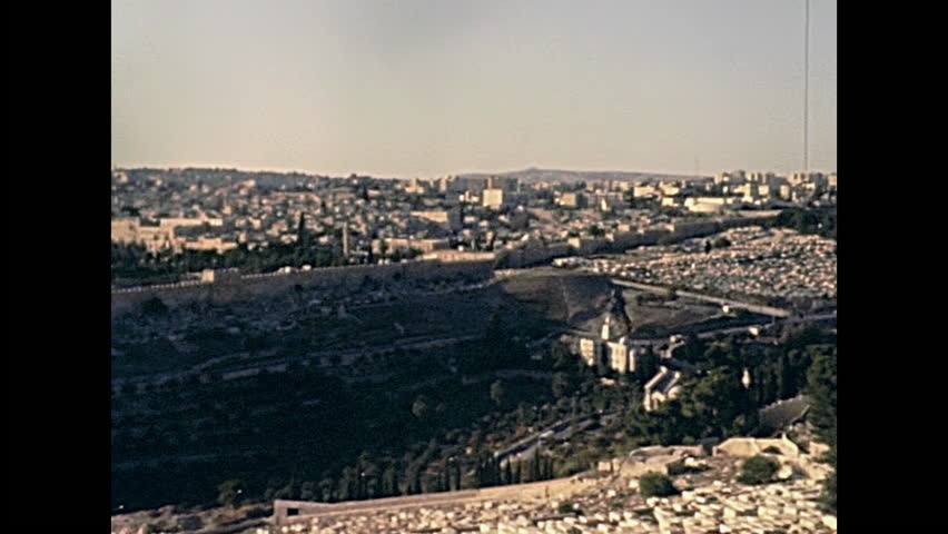 Aerial view close up of Dome of the Rock of Islamic shrine on the Temple Mount and walls of the Old City of Jerusalem on 80s in Israel. Also called Qubbat As-Sakhrah. Historic restored 1980s footage.