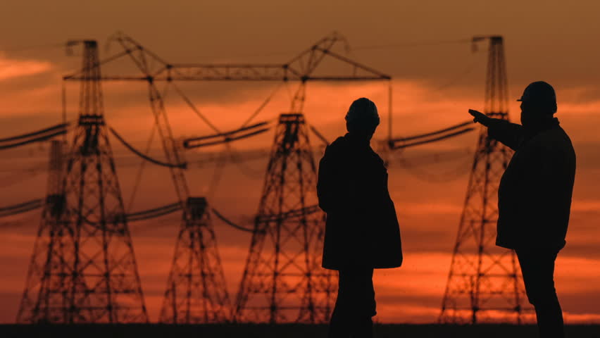 Wide shot of two engineers in hard hat vigorously discussing something at red sunset during an energy substation inspection. | Shutterstock HD Video #26949451