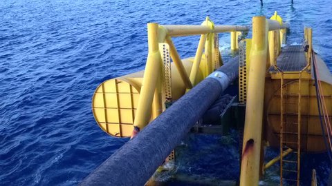 Underwater pipe laying moving on the stinger structure of pipelay accommodation barge at South China Sea, Sarawak, Malaysia in time lapse mode.
 