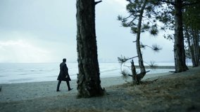 Camera follows a lonely businessman walking on the beach near iced lake.  Shot on RED EPIC-W 8K Helium Cinema Camera in Slow Motion.
