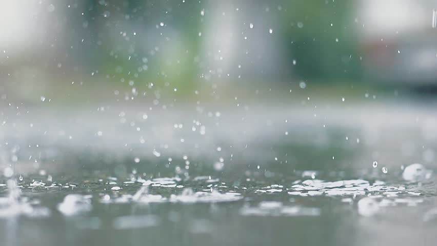 It is raining outside. Rain drops break in puddle. Slow motion. Close up.  Royalty-Free Stock Footage #26961493