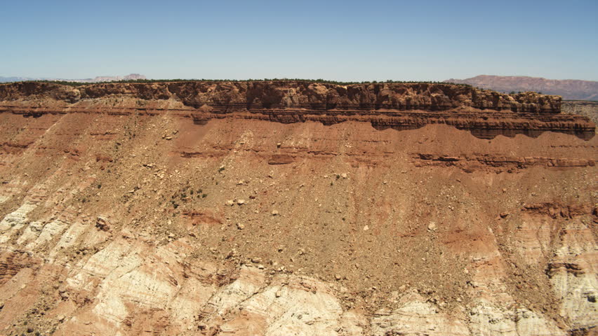 Over a tree-covered butte in the desert southeast of Hurricane, Utah. Shot in June 2013.