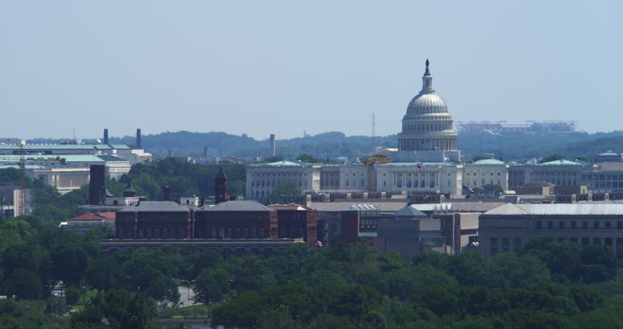 Dome of the US Capitol Building with Smithsonian Castle at left. Shot in 2012.