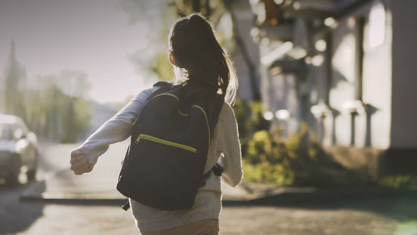 Child running with a school bag in sunny day. Steadicam shot. Slow motion 100 fps Royalty-Free Stock Footage #26967268