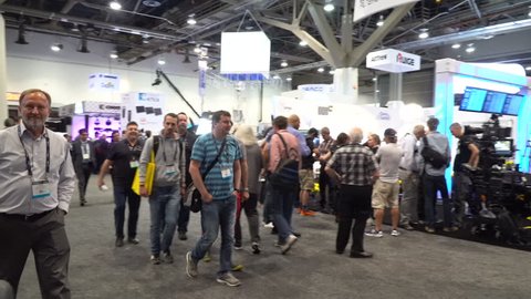 Las Vegas, USA - April 2017: NAB trade show floor at Las Vegas convention center. Industry tech people walk the showroom visit company booths new announcements a products. Gift bags of swag